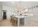 Bright kitchen features a large center island, stainless steel appliances, and custom cabinetry at 107 Owens Mill Place, Canton, GA 30115