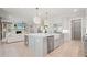Open-concept kitchen with a large island, stainless steel appliances, and views of the living room at 107 Owens Mill Place, Canton, GA 30115