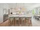 Bright kitchen with large island, marble countertop, pendant lighting, stainless fridge and seating at 107 Owens Mill Place, Canton, GA 30115