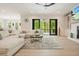 Bright living room with white sectional, fireplace, and doors to an outdoor patio with wooded views at 107 Owens Mill Place, Canton, GA 30115