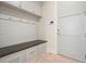 Mudroom with coat hooks, a built-in bench with storage, and access to the main house at 107 Owens Mill Place, Canton, GA 30115