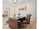 Office with a dark wood desk and a leather chair with a neutral-toned floor and artwork at 107 Owens Mill Place, Canton, GA 30115