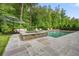 The pool's stone patio offers ample space for lounging and entertaining at 107 Owens Mill Place, Canton, GA 30115