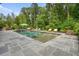 The pool is nestled among lush greenery, creating a serene and private retreat at 107 Owens Mill Place, Canton, GA 30115