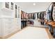 Spacious walk-in closet with custom shelving, drawers, and ample hanging space for organized storage at 107 Owens Mill Place, Canton, GA 30115