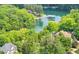 Breathtaking lakefront home nestled among lush trees with private dock access for serene waterfront living at 1455 Lockridge Dr, Cumming, GA 30041