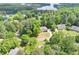 Aerial view of a home with lake views, surrounded by lush trees at 1455 Lockridge Dr, Cumming, GA 30041