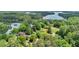 Aerial view of a home with lake views, surrounded by lush trees at 1455 Lockridge Dr, Cumming, GA 30041