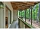 Covered porch provides a serene outdoor space with views of the surrounding lush greenery at 1455 Lockridge Dr, Cumming, GA 30041