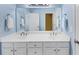 Bathroom with blue walls, double vanity, and a large mirror at 1455 Lockridge Dr, Cumming, GA 30041