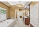 Bathroom showcasing a tub, bright natural light and double doors at 1455 Lockridge Dr, Cumming, GA 30041