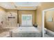 Bright bathroom featuring a walk-in shower, tub, and natural light at 1455 Lockridge Dr, Cumming, GA 30041