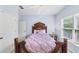 Bedroom featuring wood-carved bed frame, ceiling fan, carpet and large window at 1455 Lockridge Dr, Cumming, GA 30041