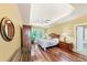 Bright bedroom featuring a tray ceiling, ceiling fan, and hardwood floors at 1455 Lockridge Dr, Cumming, GA 30041