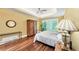 Bedroom with tray ceiling, ceiling fan, and hardwood floors at 1455 Lockridge Dr, Cumming, GA 30041