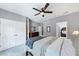 Bedroom features closet doors, neutral walls, ceiling fan, and a view into an additional bedroom at 1455 Lockridge Dr, Cumming, GA 30041