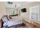 Bedroom with carpet and a bed and a television attached to the wall at 1455 Lockridge Dr, Cumming, GA 30041