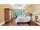 Bedroom featuring a tray ceiling, hardwood floors, and natural light at 1455 Lockridge Dr, Cumming, GA 30041