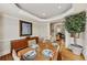 Dining room with hardwood floors, table set for six, and a view to the living room at 1455 Lockridge Dr, Cumming, GA 30041