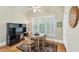 Cozy dining area with vaulted ceilings, light hardwood floors, and window shutters at 1455 Lockridge Dr, Cumming, GA 30041
