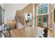 Bright foyer with hardwood floors, decorative glass front door, and stairs to the second floor at 1455 Lockridge Dr, Cumming, GA 30041