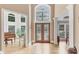 Grand foyer featuring decorative glass doors, hardwood floors, and abundant natural light at 1455 Lockridge Dr, Cumming, GA 30041