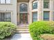 Elegant front entrance with stone accents, steps, and a decorative glass double-door at 1455 Lockridge Dr, Cumming, GA 30041