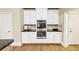 Kitchen features new stainless steel appliances, white cabinets, and granite countertops at 1455 Lockridge Dr, Cumming, GA 30041