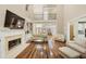Spacious living room featuring a fireplace, vaulted ceiling, hardwood floors, and a view of the second floor at 1455 Lockridge Dr, Cumming, GA 30041