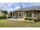 Lush backyard features stone patio, landscaped garden beds, and views of the home's exterior and surrounding trees at 710 Eastbourne Ct, Alpharetta, GA 30005
