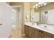Bathroom with double sinks, vanity, and wood-look flooring offering ample space and functionality at 710 Eastbourne Ct, Alpharetta, GA 30005