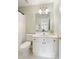 Well-lit bathroom features white vanity, elegant light fixture, and a view to the home's interior at 710 Eastbourne Ct, Alpharetta, GA 30005