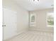 An empty bedroom with neutral carpet, two windows, and a closet providing a blank canvas for new owners at 710 Eastbourne Ct, Alpharetta, GA 30005