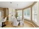 Charming breakfast nook features a modern chandelier, large windows, and a built-in display cabinet at 710 Eastbourne Ct, Alpharetta, GA 30005