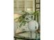 Close-up of breakfast nook featuring a glass table, decorative greenery, and a built-in cabinet at 710 Eastbourne Ct, Alpharetta, GA 30005