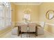 Elegant dining room with modern chandelier, a light color palette and beautiful hardwood floors at 710 Eastbourne Ct, Alpharetta, GA 30005