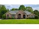 Charming brick home with manicured lawn and mature landscaping, creating inviting curb appeal at 710 Eastbourne Ct, Alpharetta, GA 30005