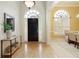 Bright foyer with hardwood floors, a transom window, and an adjacent dining area at 710 Eastbourne Ct, Alpharetta, GA 30005