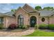 Inviting front entrance with brick facade, arched windows, and lush landscaping at 710 Eastbourne Ct, Alpharetta, GA 30005