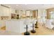 Kitchen boasts white cabinets, stainless steel appliances, a breakfast bar, and modern lighting at 710 Eastbourne Ct, Alpharetta, GA 30005