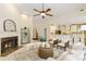 Inviting living room featuring a fireplace, plush seating, and seamless open floorplan to the kitchen at 710 Eastbourne Ct, Alpharetta, GA 30005