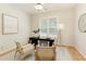 Bright office space with hardwood floors, a black desk, stylish chairs, and natural light from a window at 710 Eastbourne Ct, Alpharetta, GA 30005