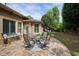 Outdoor stone patio boasts dining area, small bistro set, and views of the beautifully landscaped backyard at 710 Eastbourne Ct, Alpharetta, GA 30005