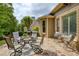 Stone patio with outdoor dining set, grill, and lush landscaping, perfect for entertaining or relaxing outdoors at 710 Eastbourne Ct, Alpharetta, GA 30005