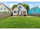 Spacious backyard with lush green grass, wood privacy fence, and patio at 969 Oak Sw St, Atlanta, GA 30310