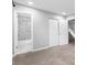 Bedroom featuring neutral carpet, ensuite bathroom with marble shower, and white closet doors at 969 Oak Sw St, Atlanta, GA 30310