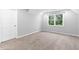 Bedroom with a large window, white door, and neutral carpet at 969 Oak Sw St, Atlanta, GA 30310