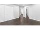 Large bedroom with dark wood floors and white closets and doors at 969 Oak Sw St, Atlanta, GA 30310