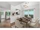 Bright dining area featuring hardwood floors, modern chandelier, and an open view to the kitchen and a door at 969 Oak Sw St, Atlanta, GA 30310