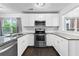 Well-lit kitchen with stainless steel appliances, granite counters, white subway tile backsplash, and dark hardwood floors at 969 Oak Sw St, Atlanta, GA 30310